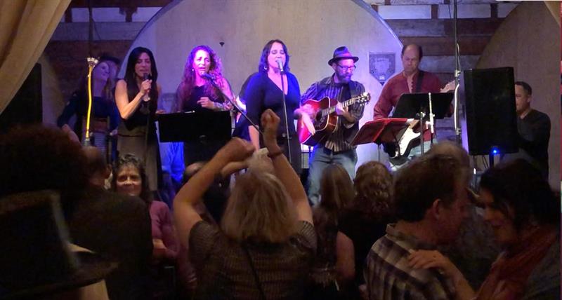 Enjoyus performing indoors in front of a dancing crowd